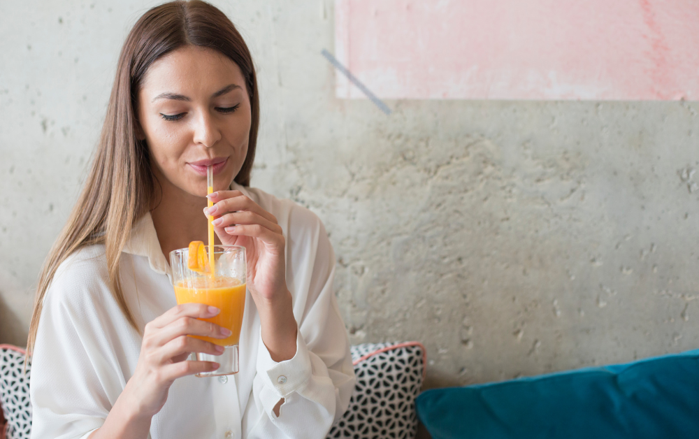 woman drinking through a straw